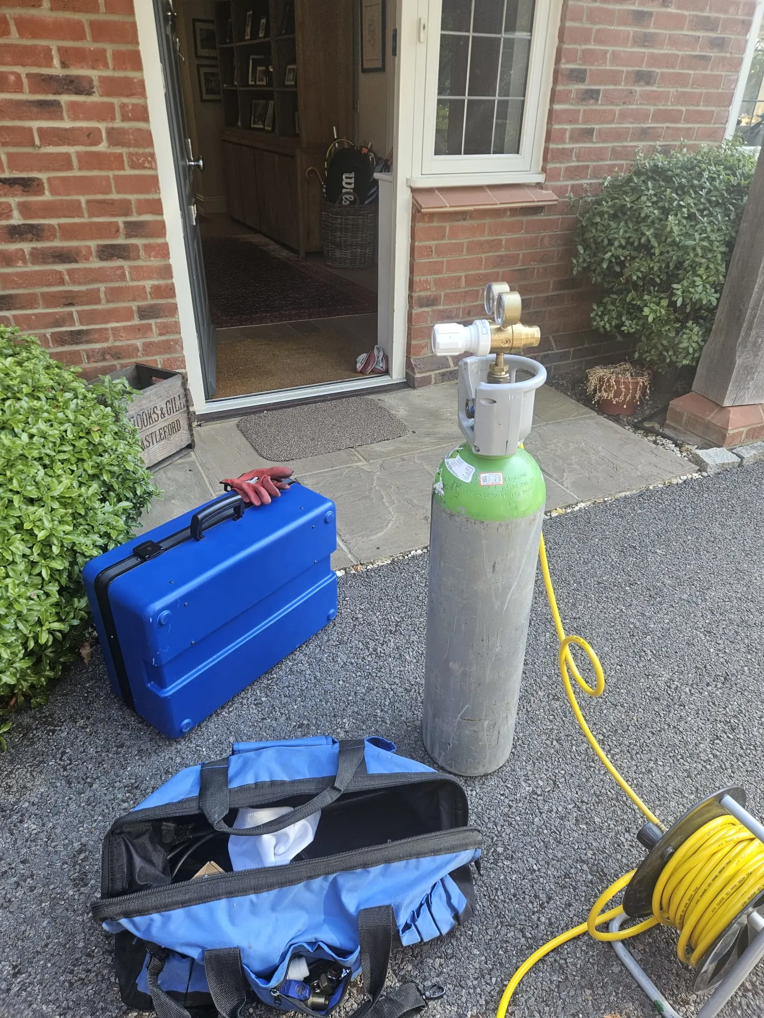 Tracer gas cylinder and test equipment set up outside a property