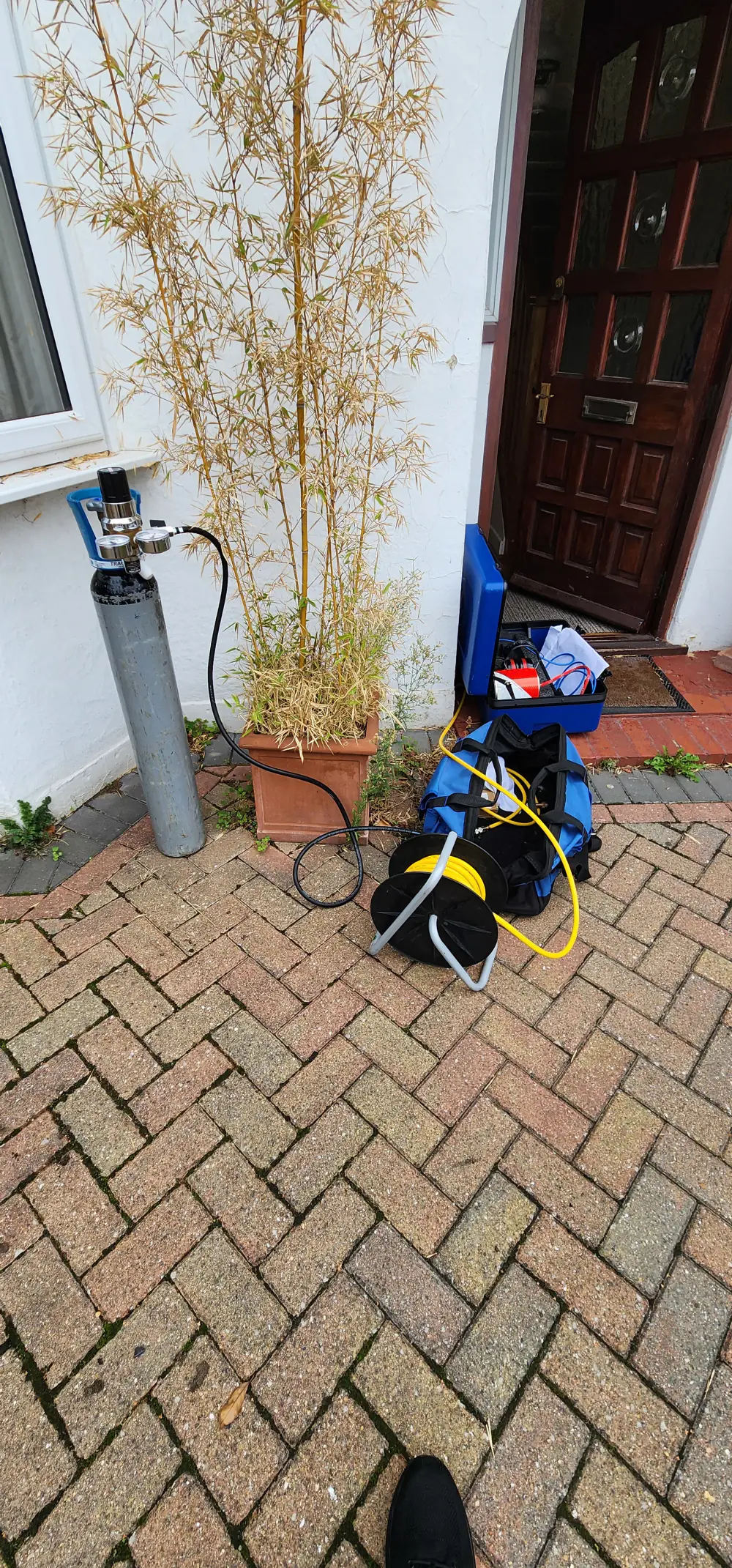 Tracer gas cylinder and leak detection equipment set up outside a Twickenham property