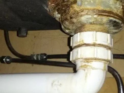 Bathroom waste pipe leak investigation around sanitary fittings